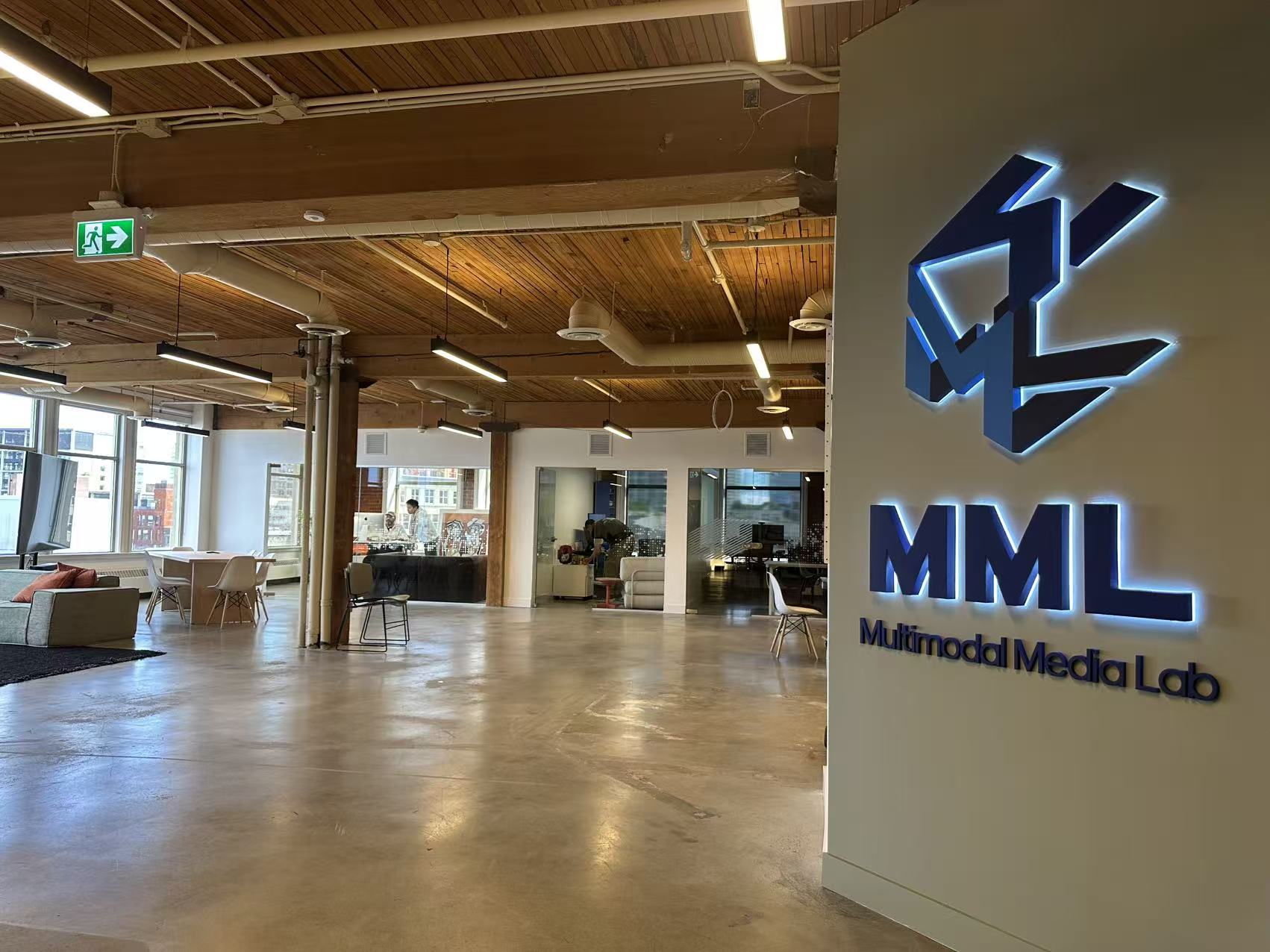 MML entrance with illuminated logo wall and open event floor