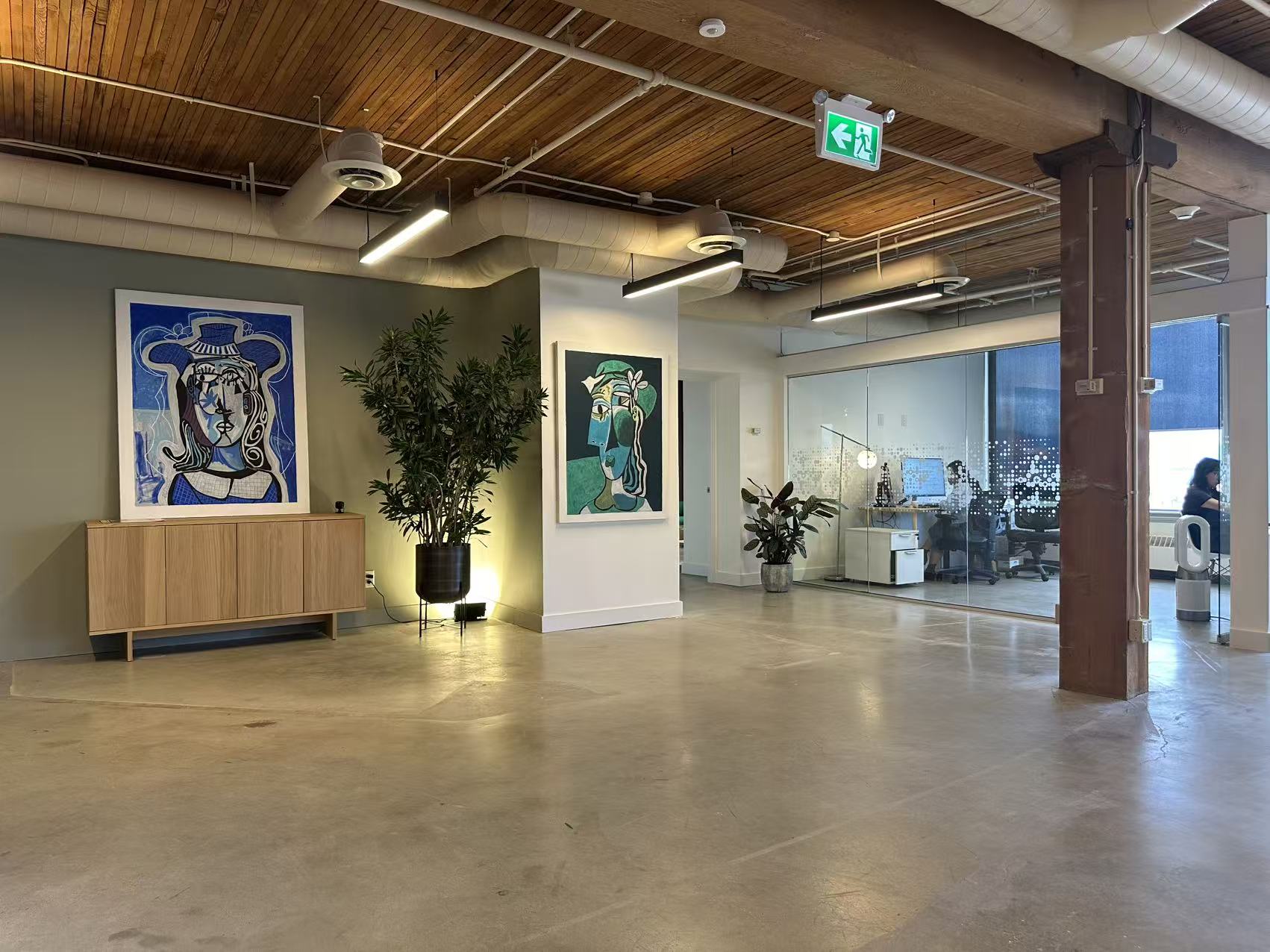 Gallery-style open space with artwork and plants