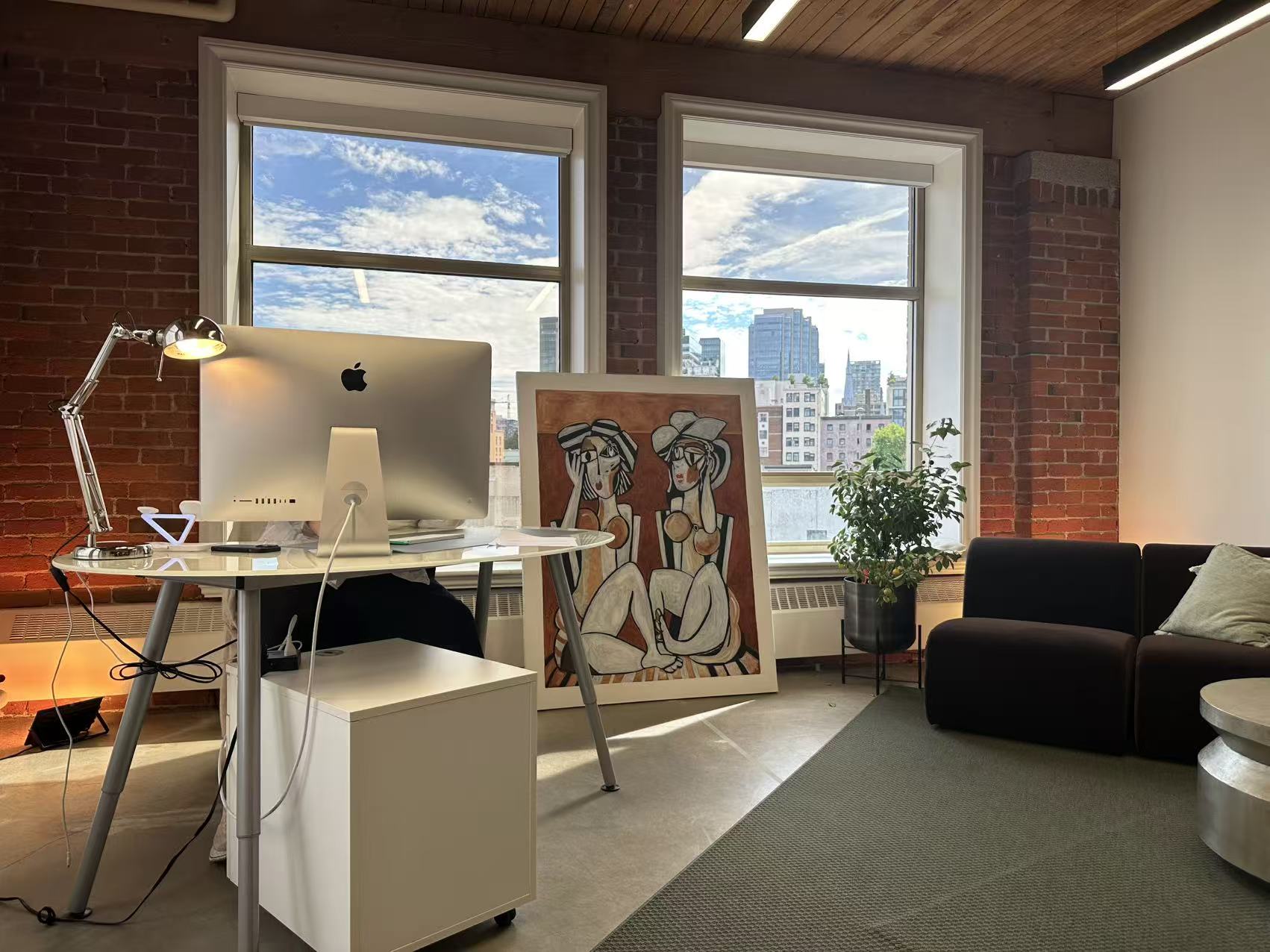 Creative studio corner with exposed brick and artwork